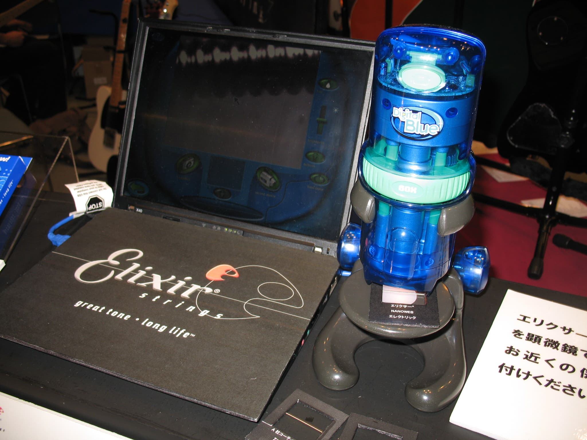 Elixir string magnified through microscope connected to laptop.